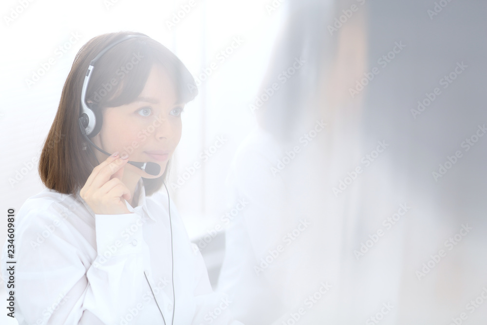Call center. Group of operators at work. Focus on young brunette woman. Business concept Call center. Group of operators at work. Focus on young brunette woman. Business concept