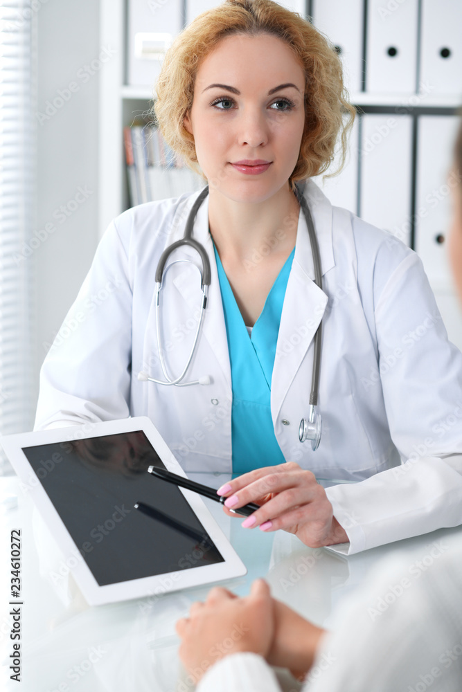 Happy blonde female doctor and patient discussing medical examination results. Medicine, healthcare and help concept Happy blonde female doctor and patient discussing medical examination results. Medicine, healthcare and help concept