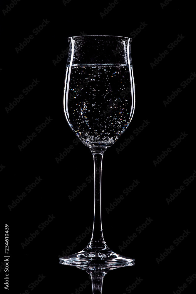 Fototapeta premium glass of white wine isolated on black background