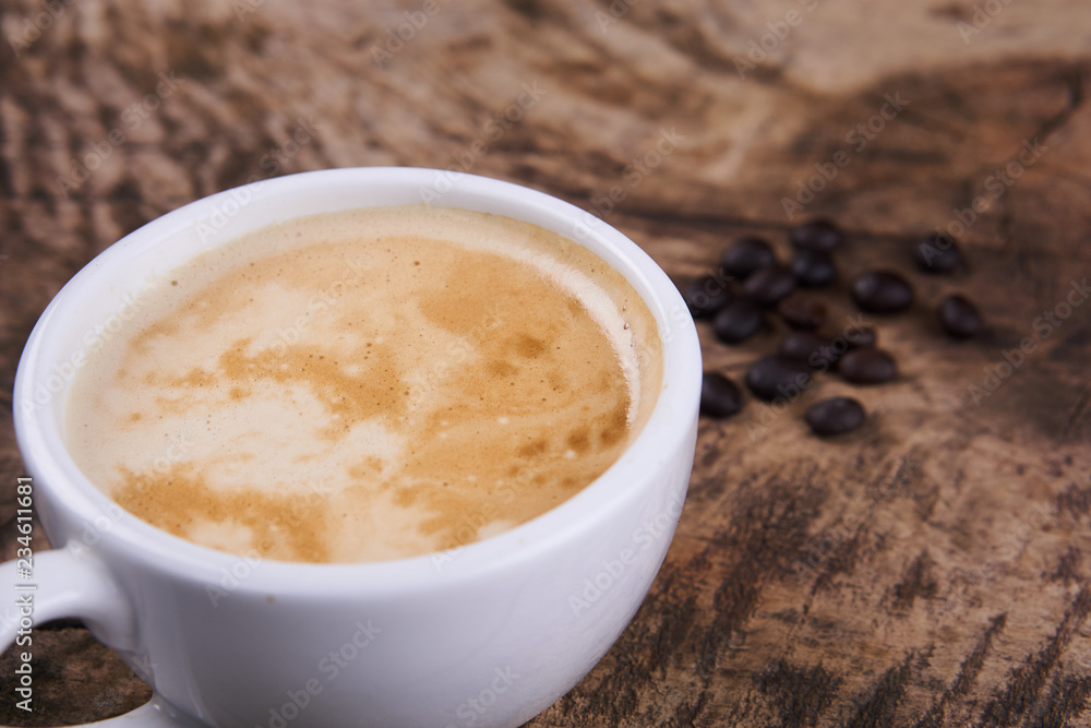 Cappuccino and latte art on the wood table. Free hand pouring some milk on the coffee. Morning breakfast with coffee. Cappuccino and latte art on the wood table. Free hand pouring some milk on the coffee. Morning breakfast with coffee.