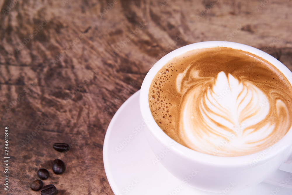 Cappuccino and latte art on the wood table. Free hand pouring some milk on the coffee. Morning breakfast with coffee. Cappuccino and latte art on the wood table. Free hand pouring some milk on the coffee. Morning breakfast with coffee.
