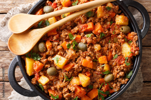 Picadillo Recipe Ground beef, carrot and potatoes cooked in a tomato sauce closeup on a pan. horizontal top view photo