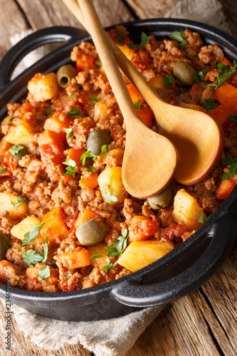 This picadillo recipe is an easy, warm and comforting Mexican dish made from ground beef and potatoes cooked in a flavorful sauce closeup. Vertical