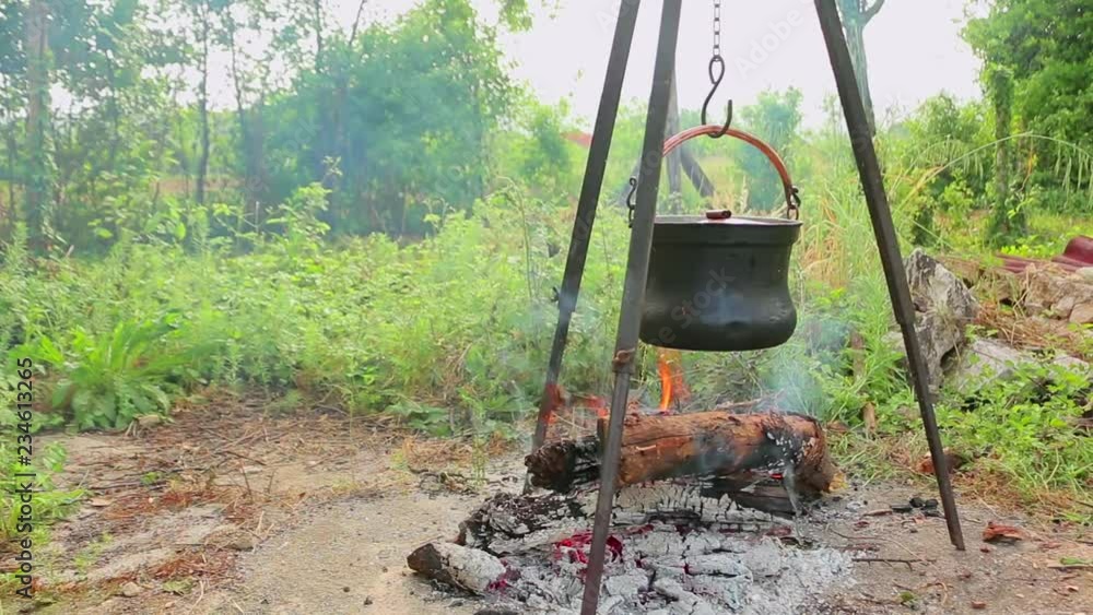 Cooking on fire in cast iron cauldron slider shoot. Cooking soup with meat and potatoes in cast iron cauldron Cooking on fire in cast iron cauldron slider shoot. Cooking soup with meat and potatoes in cast iron cauldron