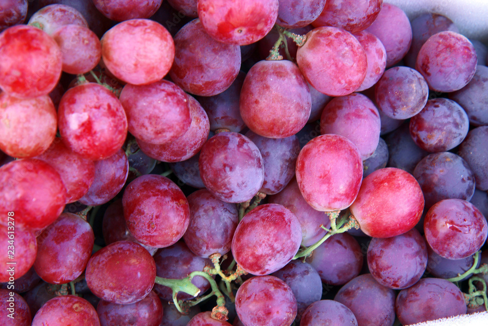 A background of fresh, healthy, purple grapes A background of fresh, healthy, purple grapes
