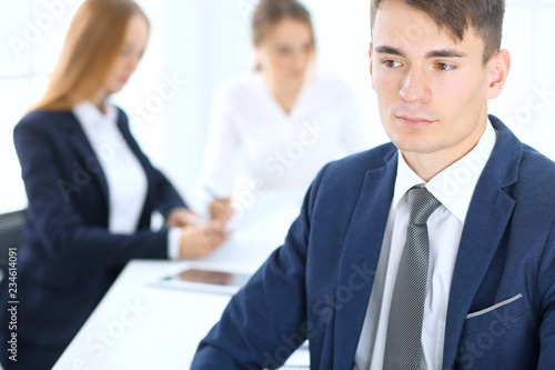 Wallpaper Mural Group of business people or lawyers discussing terms of transaction in office. Focus at young businessman. Meeting and teamwork concept Torontodigital.ca