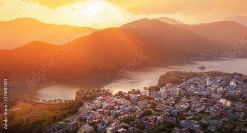 he sunset sky above the city of Pokhara and Phewa lake with World Peace Pagoda on the top of hill. Nepal photo