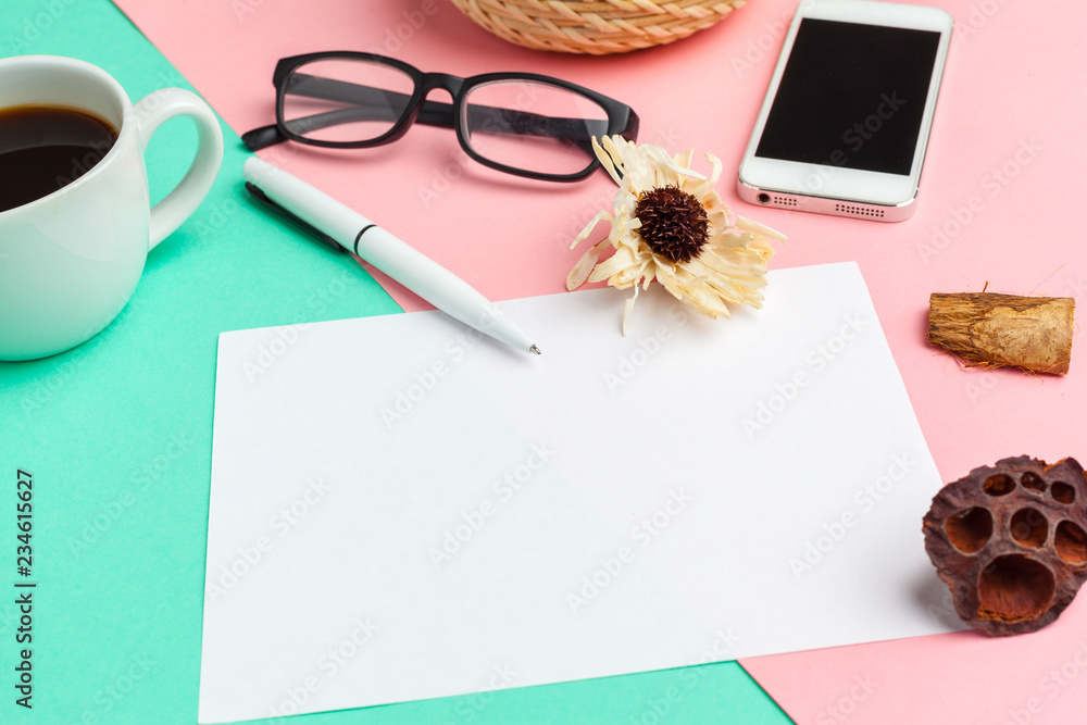Blank paper with smart phone on desk.top view,flat lay Blank paper with smart phone on desk.top view,flat lay