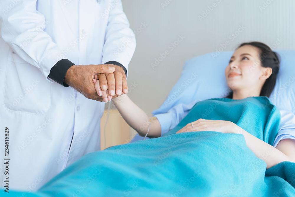 Hands doctor reassuring her female patient in hospital room,Doctor giving a consultation and encouragement to patient,Mental health care concept Hands doctor reassuring her female patient in hospital room,Doctor giving a consultation and encouragement to patient,Mental health care concept
