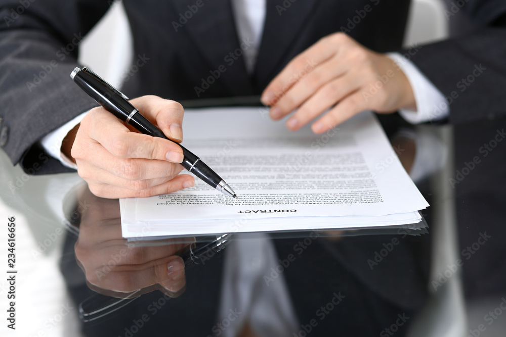 Close-up of female hands with pen over document of contact, business concept Close-up of female hands with pen over document of contact, business concept