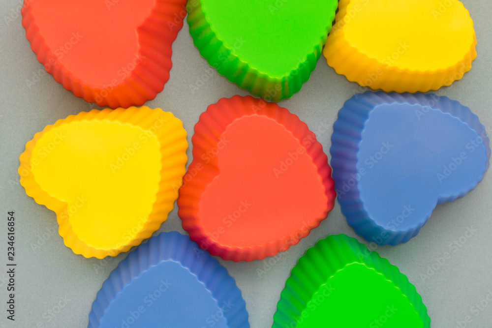 Multi-colored baking molds on a light background Multi-colored baking molds on a light background