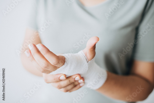 Woman with gauze bandage wrapped around her hand photo