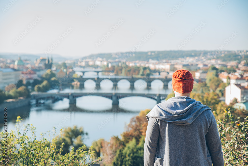 man on the hill looking at panorama view of european city