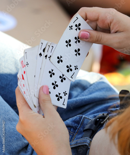 Girl holds playing cards
