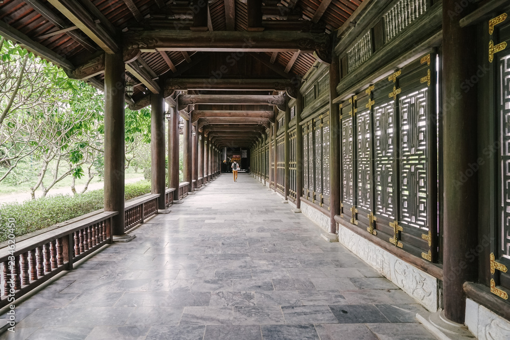Looking down a long corridor in a Vietnamese temple on an adventure exploring Asia Looking down a long corridor in a Vietnamese temple on an adventure exploring Asia