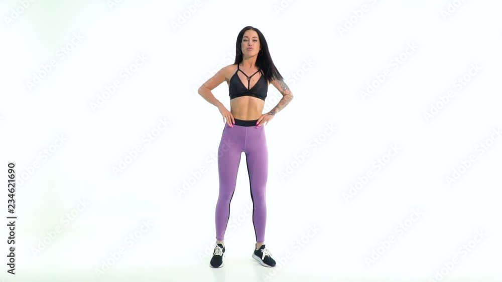 Athletic brunette walking out and posing on white background Athletic brunette walking out and posing on white background