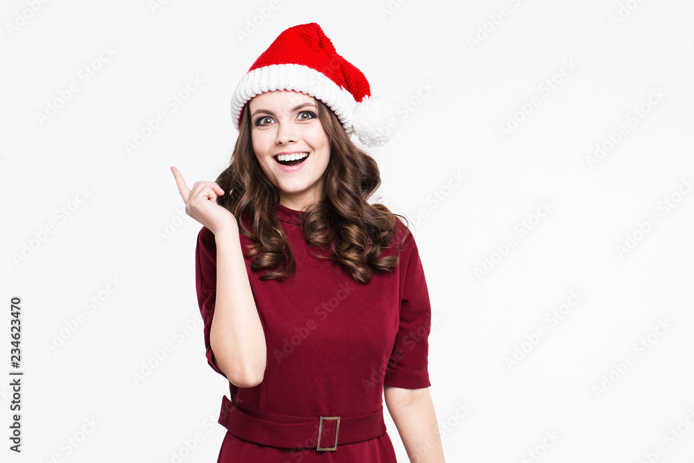Beautiful woman thumbs up in christmas santa claus red hat smiling getting ready to celebrate new year. Beautiful woman thumbs up in christmas santa claus red hat smiling getting ready to celebrate new year.