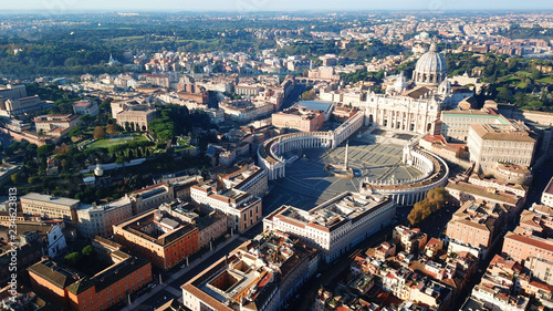 Aerial drone view of Saint Peter's square in front of world's largest church - Papal Basilica of St. Peter's, Vatican - an elliptical esplanade created in the mid seventeenth century, Rome, Italy