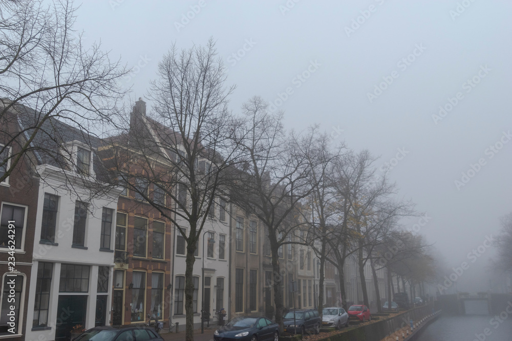 Canal houses in the mist. Oosthaven Gouda, The Netherlands.