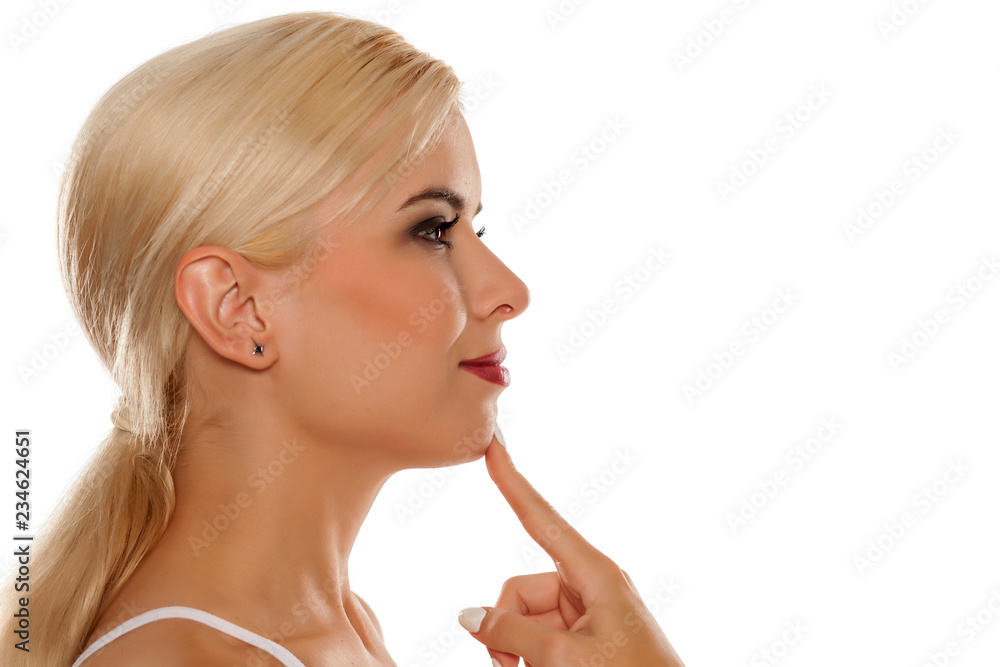 Portrait of beautiful blonde woman touching her chin on white background Portrait of beautiful blonde woman touching her chin on white background