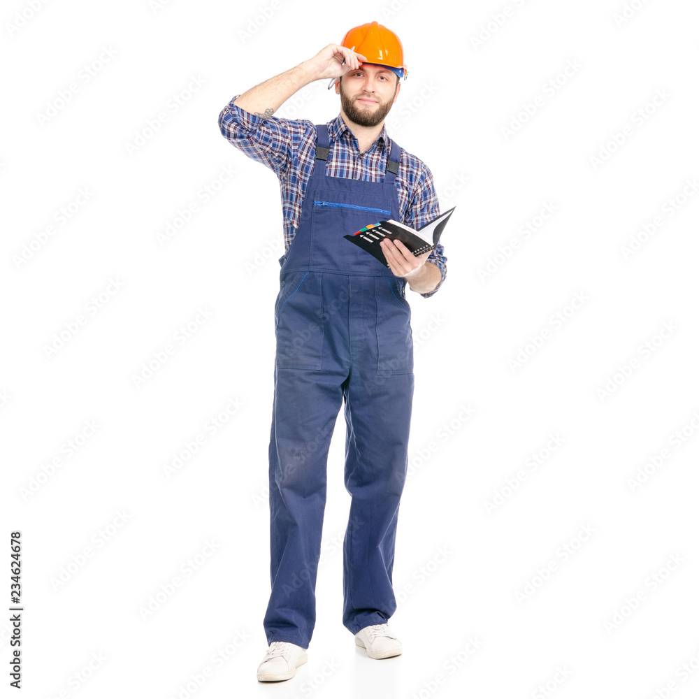 Young man builder industry worker hardhat with a notebook and pen in hand on white background isolation Young man builder industry worker hardhat with a notebook and pen in hand on white background isolation