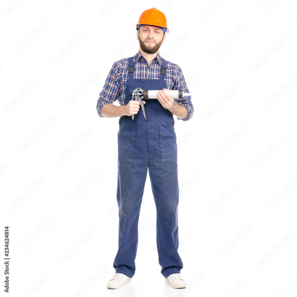 Young man builder industry worker hardhat with a silicone gun on white background isolation Young man builder industry worker hardhat with a silicone gun on white background isolation