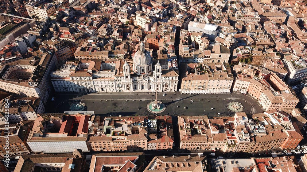 Aerial drone view of iconic landmark Piazza Navona Square featuring Fountain of the Four Rivers with an Egyptian obelisk and Sant Agnese Church in the heart of Rome, Italy