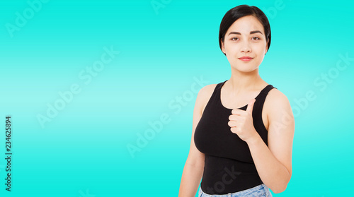 portrait of modern successful asian,korean woman shows like isolated on blue background, copy space photo