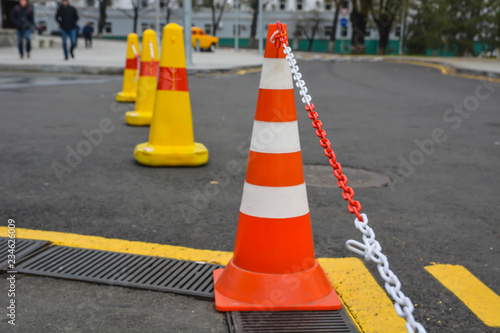 Traffic cone on the asphalt. Blury.