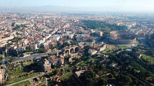 Aerial drone view from Roman Forum one of the main tourist attractions which was build in ancient times as the site of triumphal processions and elections next to Colosseum  Rome  Italy