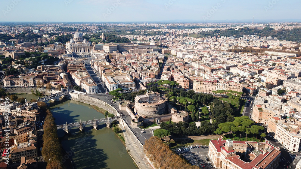Aerial drone view of iconic Castel Sant' Angelo (castle of Holy Angel) and Ponte or bridge Sant'Angelo with statues in river of Tiber next to famous Vatican, Rome, Italy