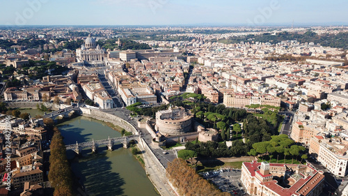 Aerial drone view of iconic Castel Sant' Angelo (castle of Holy Angel) and Ponte or bridge Sant'Angelo with statues in river of Tiber next to famous Vatican, Rome, Italy © aerial-drone