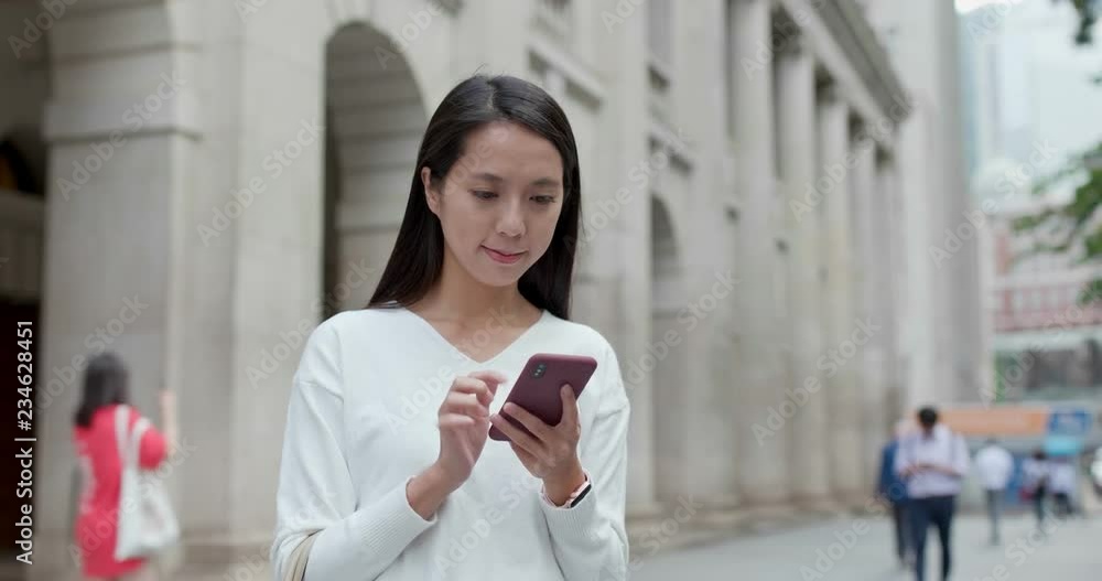 Woman look at smart phone for searching location Woman look at smart phone for searching location