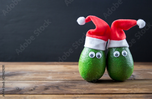 Christmas avocado couple. avocado in christmas hat