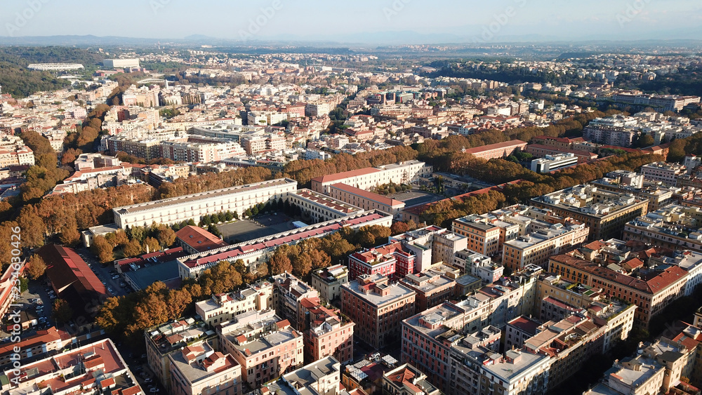 Aerial drone bird's eye view of iconic architecture in city of Rome next to river Tiber, Italy