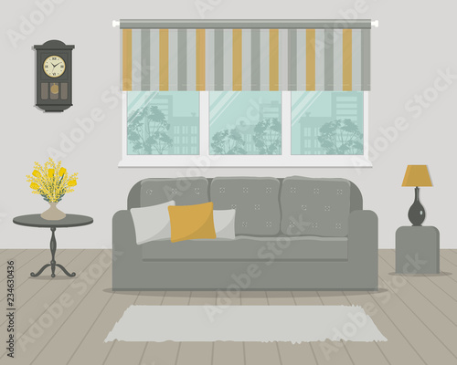 Living room in gray and yellow colors. There is a sofa with pillows and a lamp against a window with striped curtains. There is also a bouquet of tulips and mimosa on the table, and clock on the wall
