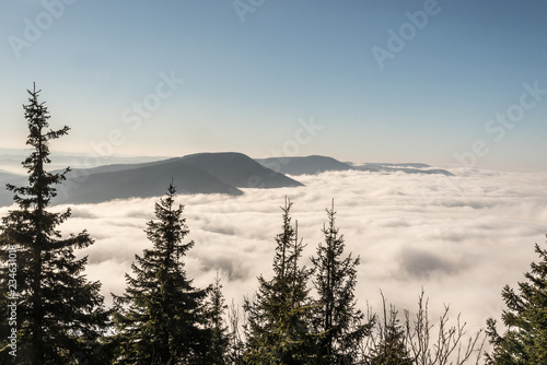 autumn Moravskoslezske Beskydy mountains scenery from Lysa hora hill in Czech republic with only highest hills above mist photo