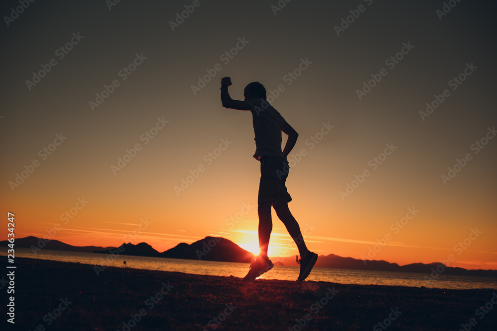 Young energetic happy man jumping on the seashore