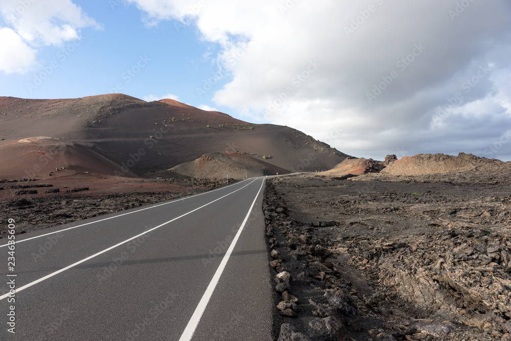Street through volcanic area in Timanfaya national park Lanzarote. Canary Islands. Spain