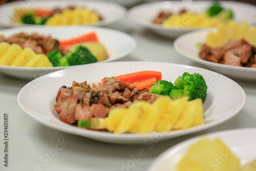 Steak pork sliced cube with vegetables such as tomatoes, carrot, broccoli and pineapple.