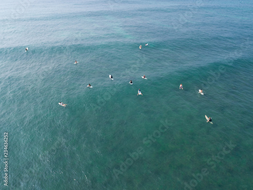 Photography Top view from drone of surfers paddling for catching  waves during surfing  in t