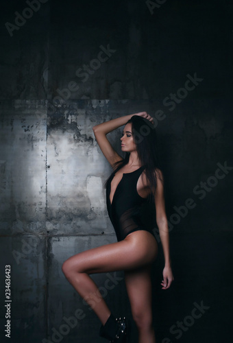 Portrait of beautiful girl in a studio on a dark background