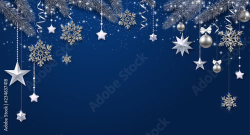 Blue shiny festive background with fir branches and Christmas decorations.