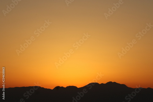 View from Enoshima island to mountain silhouettes with dramatic sunset, Fujisawa, Kanagawa prefecture, Japan