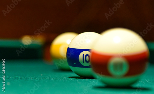 Billiard balls and cue on the pool table