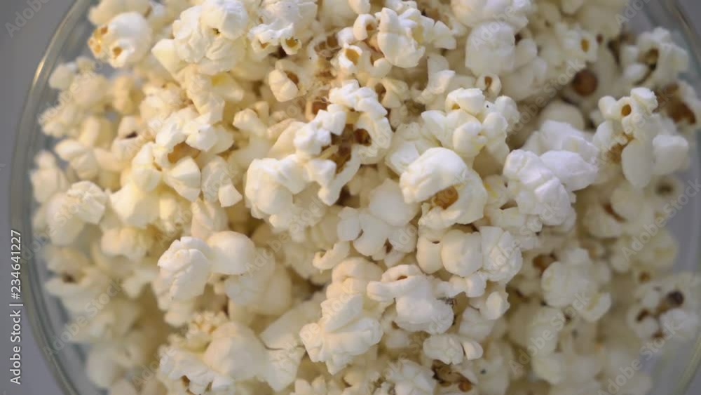 Bowl of popcorn turning around top view. Popped popcorn closeup. Bowl of popcorn turning around top view. Popped popcorn closeup.