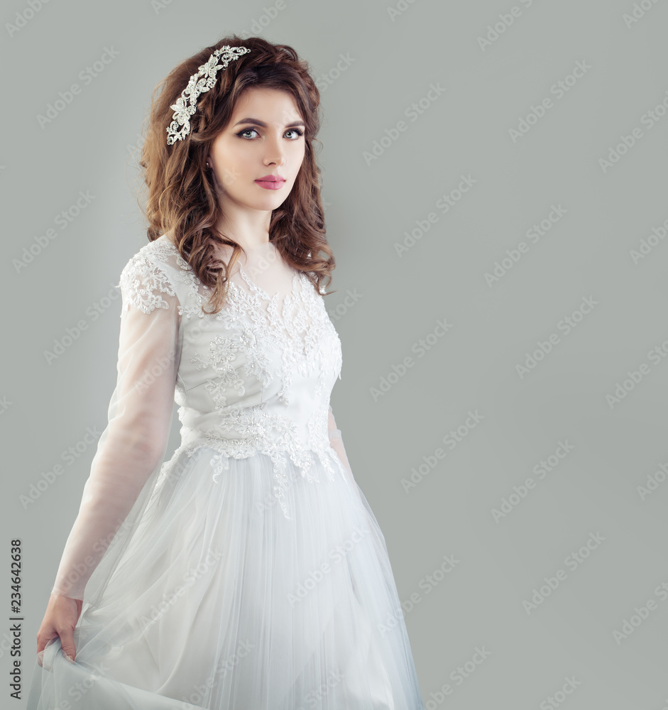 Perfect young bride woman in white wedding dress on background with copy space Perfect young bride woman in white wedding dress on background with copy space