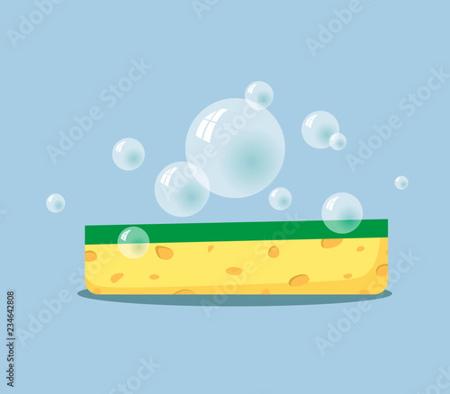 Sponge for washing dishes with soap bubbles on a blue background