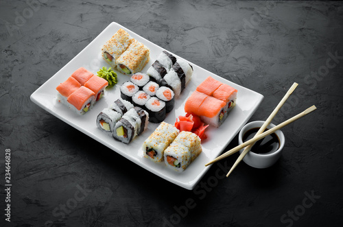 Big Set sushi with soy sauce and wasabi. Free space for your text. Top view. On a stone background.
