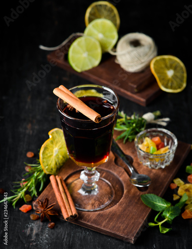 Hot winter wine cocktail. On a wooden background. Top view. Free copy space.